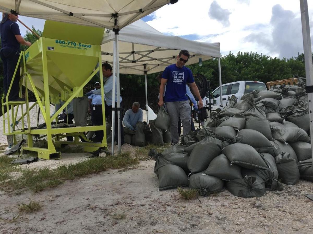 Doral city workers load sand in bags to give away to residents and business owners. People were waiting over three hours in line to get the bags.