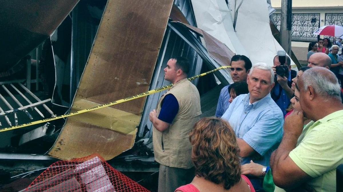 Vice President Mike Pence tours a neighborhood damaged by Hurricane Maria in San Juan, Puerto Rico, on Friday, Oct. 6, 2017.