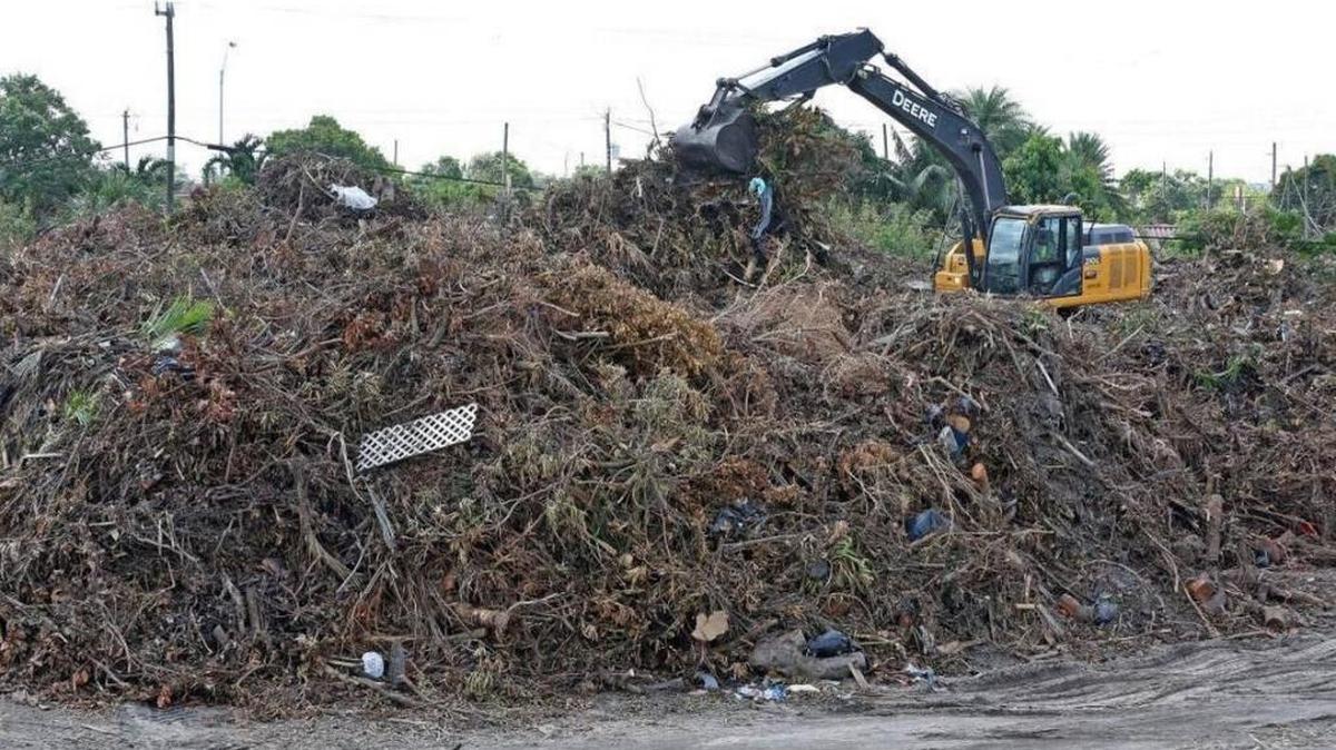 Crews drop off debris from Hurricane Irma at a FEMA staging site in Hialeah in the 5600 block of East Eighth Avenue, behind the police station, on Sept. 28, 2017.