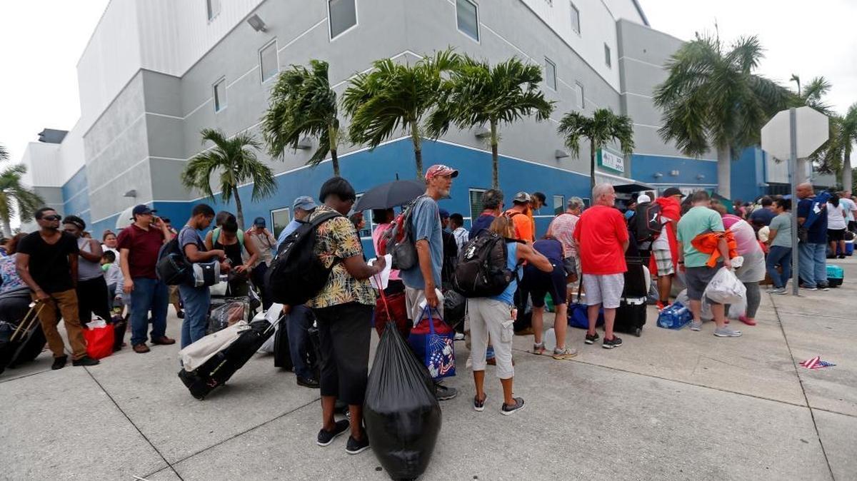 Evacuees stand in line to enter the Germain Arena, which is being used as a shelter, in advance of Hurricane Irma, in Estero, Fla., Saturday, Sept. 9, 2017. With the window closing fast for anyone wanting to escape, Irma hurtled toward Florida with 125 mph winds Saturday on a projected track that could take it away from Miami and instead give the Tampa area its first direct hit from a major hurricane in nearly a century.