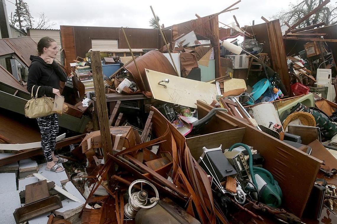 Haley Nelson inspects damage at her family’s house in the Panama City Springfield neighborhood on Thursday after Hurricane Michael made landfall Wednesday. The family’s dog, Star, was sheltered at the Pawaday Inn, a kennel that was destroyed by the winds.