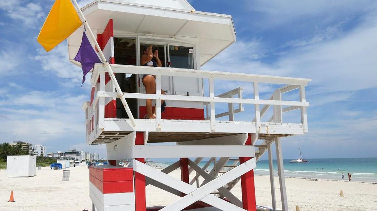 An lifeguard looks out from a lifeguard stand on Miami Beach. Ocean Rescue officials have closed the beach in advance of Hurricane Irma.