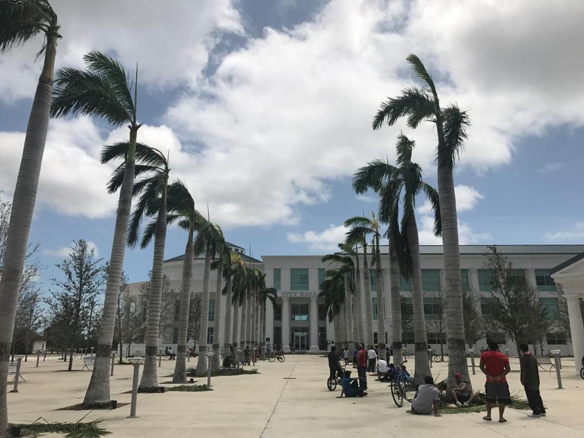 About 100 people stood outside Homestead city hall Monday afternoon to charge their phones at several outdoor electrical outlets post Hurricane Irma.