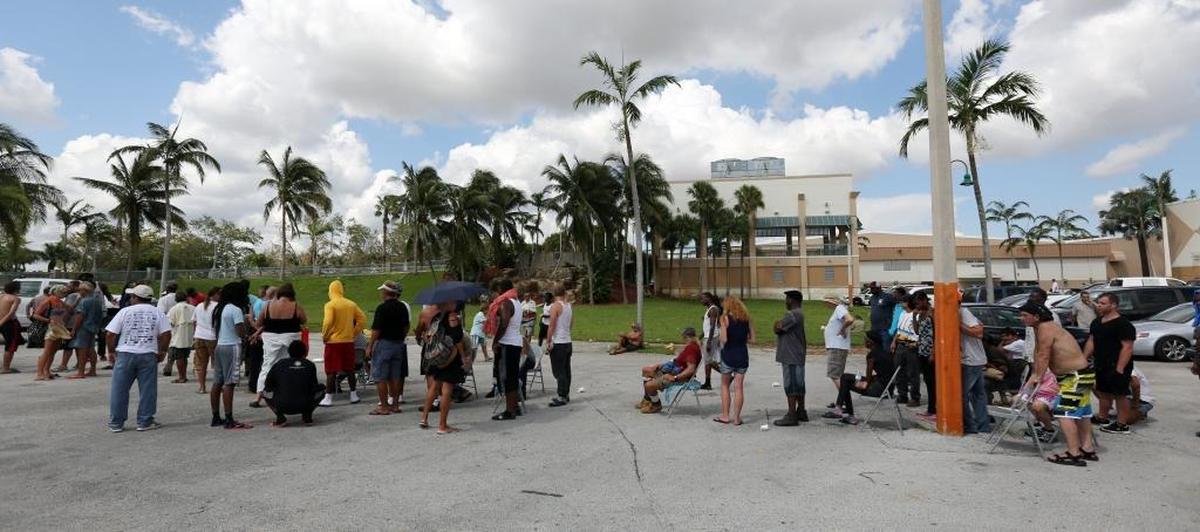 A long line formed out in the heat Thursday morning, Sept. 14, 2017, outside of the E. Darwin Fuchs Pavilion at the Miami-Dade Fairgrounds, as free phones were being given out to those in need of cell phones. The shelter is the only shelter remaining in Miami-Dade County. It's the shelter of last resort. It's housing about 1,000 people, including those who can't get back to their homes in the Florida Keys after Hurricane Irma.
