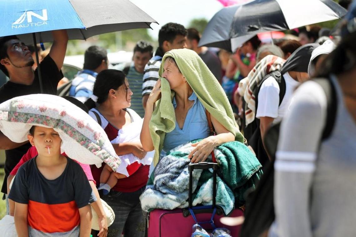 Hurricane Irma evacuees wait in line in the scorching sun for hours before entering into Robert Morgan Educational Center, which immediately was filled to its capacity of 2,400 people on Friday, September 8, 2017