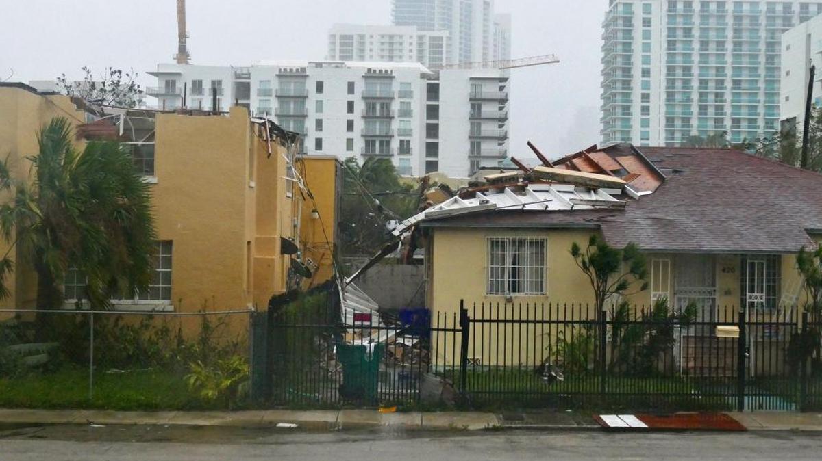 An apartment in Edgewater at the corner of Northeast Fifth Avenue and 27th Street lost its roof during Hurricane Irma’s winds Sunday. Part of the roof sits atop the neighboring house.