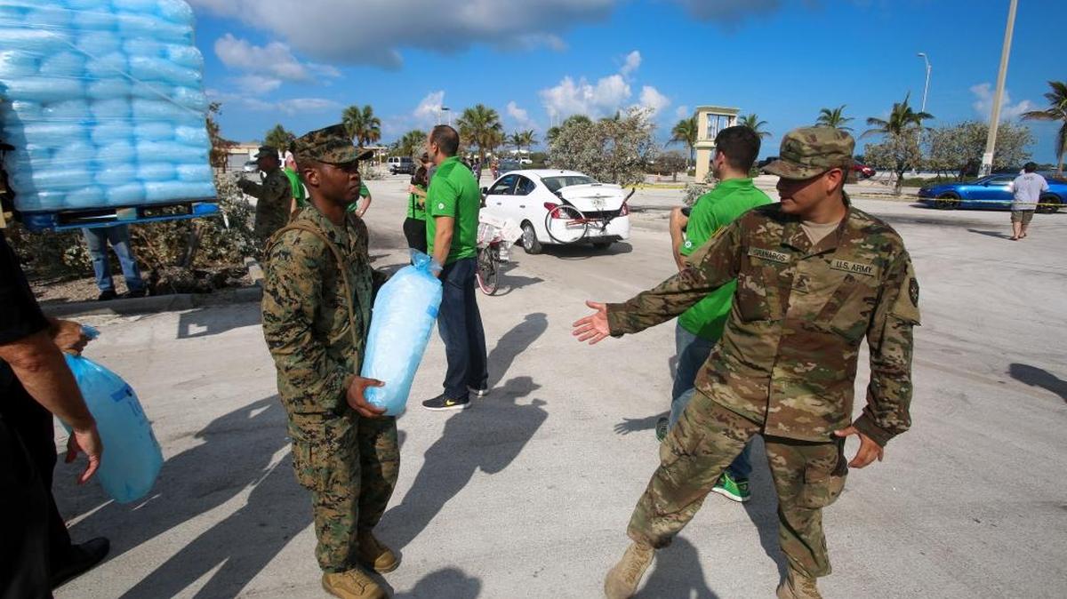 Marines and soldiers pass ice to citizens at a distribution point in Key West on Sept. 14, 2017 in this Pentagon handout photo.