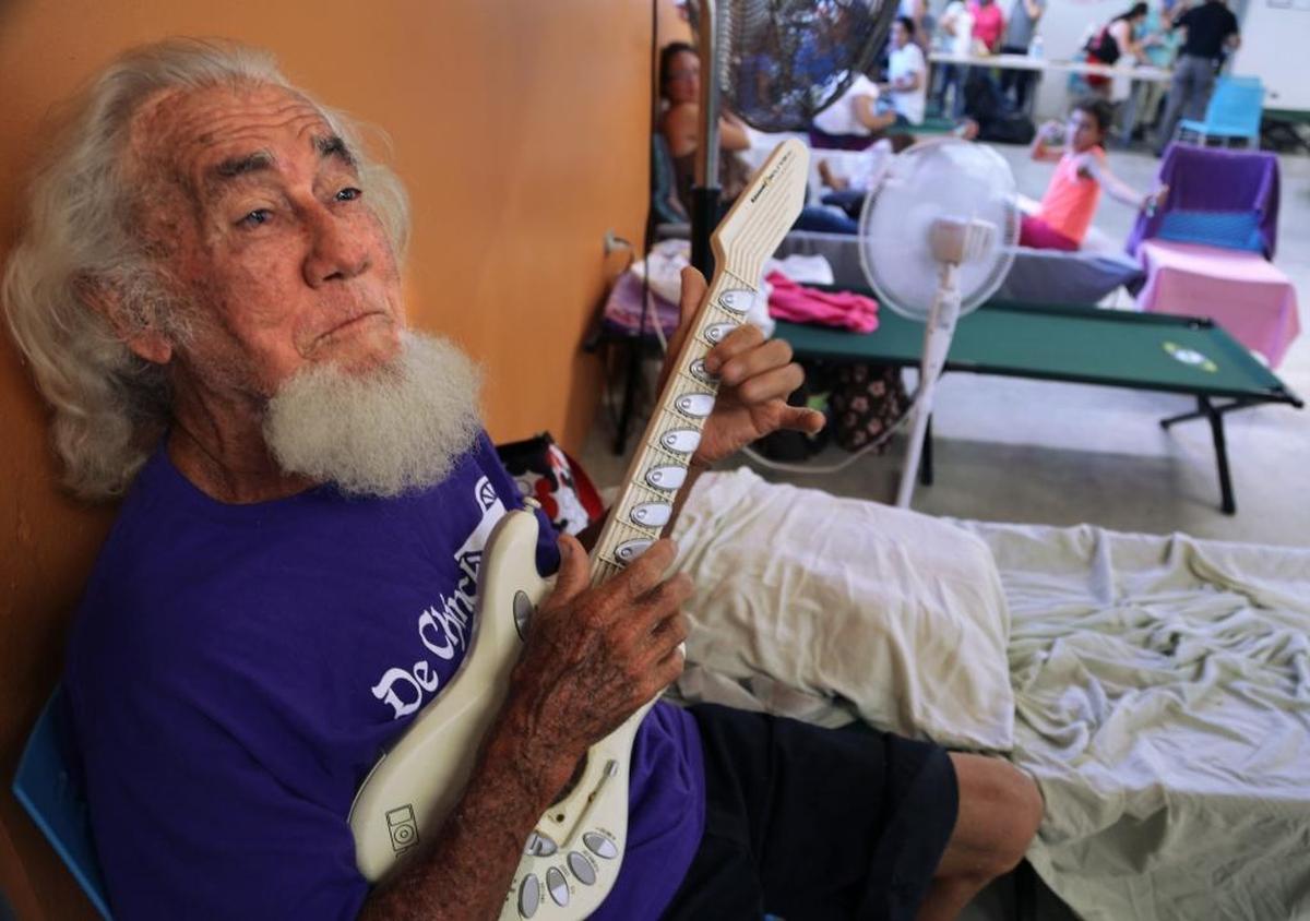 Isabela evacuee Raul Agron, 67, one of 230 people who fled due the possible breech of the Guajataca dam, entertains himself at the Francisco Mendoza High School shelter in the center of Isabela, Puerto Rico on Saturday, September 23, 2017.