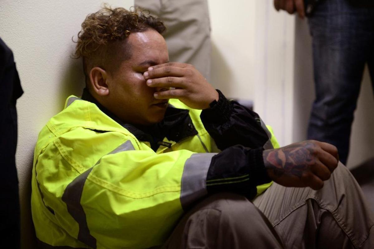 Rescue team member Jonathan Cruz cries on the floor as he is desperate to go out to attend several calls for help from citizens in need of assistance during the impact of Hurricane Maria that started to hit the eastern region of Puerto Rico, in Humacao, on Tuesday, Sept. 20, 2017.