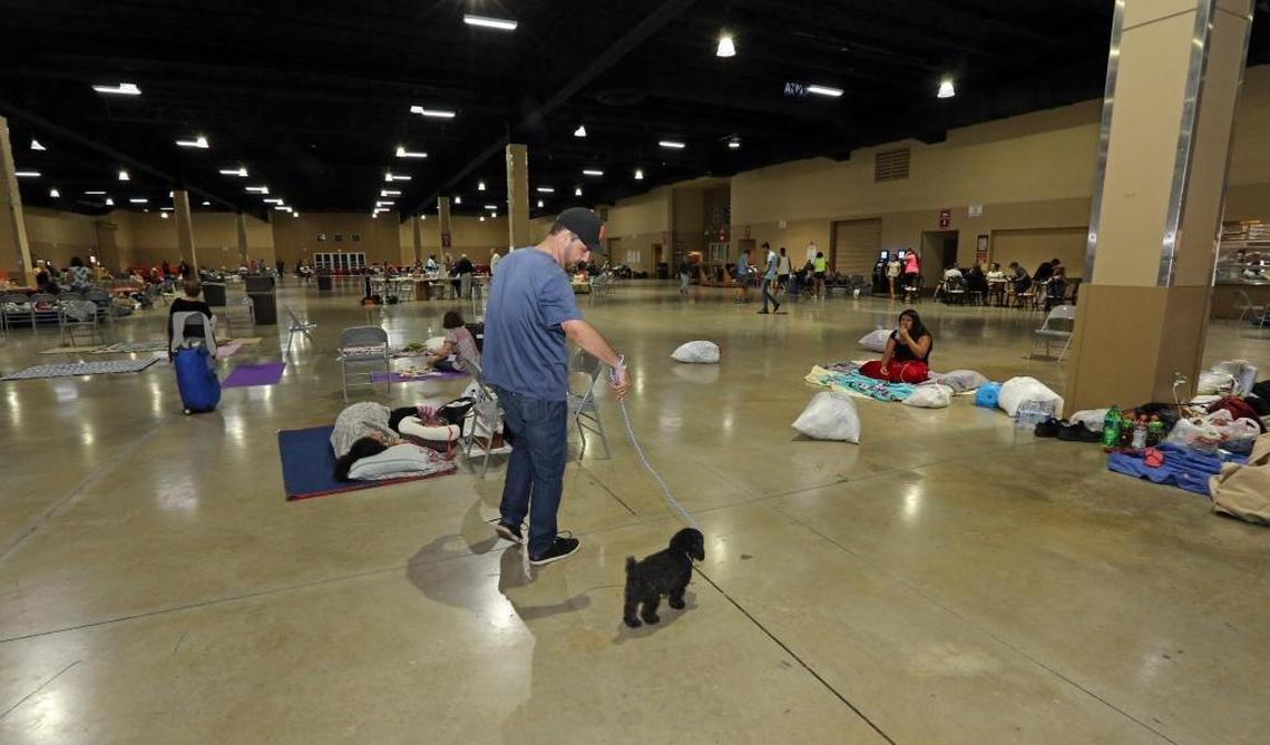 Franlix Arenal walks his dog, Brownie, around the hurricane shelter at the Miami-Dade County Fair and Exhibition, home to the Youth Fair at Tamiami Park, 10901 Coral Way, Miami in 2017.