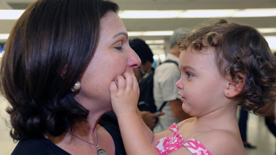 Isabel Padro de Castañer hugs her 2-year-old granddaughter Lucia at Miami International Airport after the child arrived on a flight from San Juan, Puerto Rico.