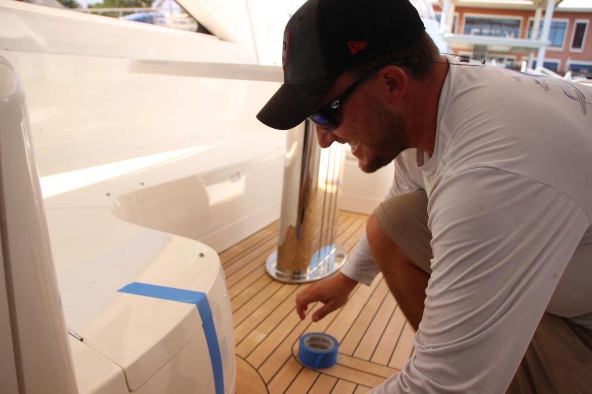 Jason Cohen secured the fourth boat he has worked on this week with blue masking tape. After working 18 hours on Wednesday, he expected to work through the evening on Thursday to prepare for Hurricane Irma.