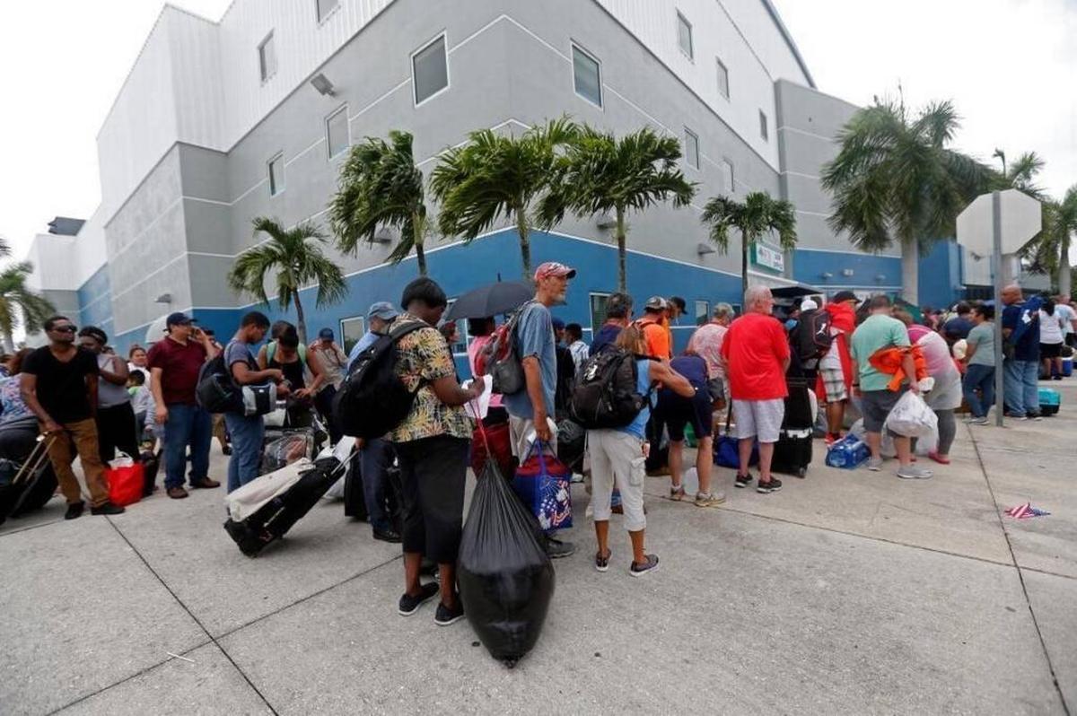 Evacuees stand in line to enter the Germain Arena, which is being used as an emergency shelter, in Estero, Fla., on Saturday.