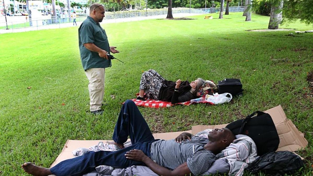 Ivan Romero, a City of Miami outreach program staff member, tries to persuade a couple of homeless people at Bayside to go to a shelter as Hurricane Irma bears down on South Florida in 2017.