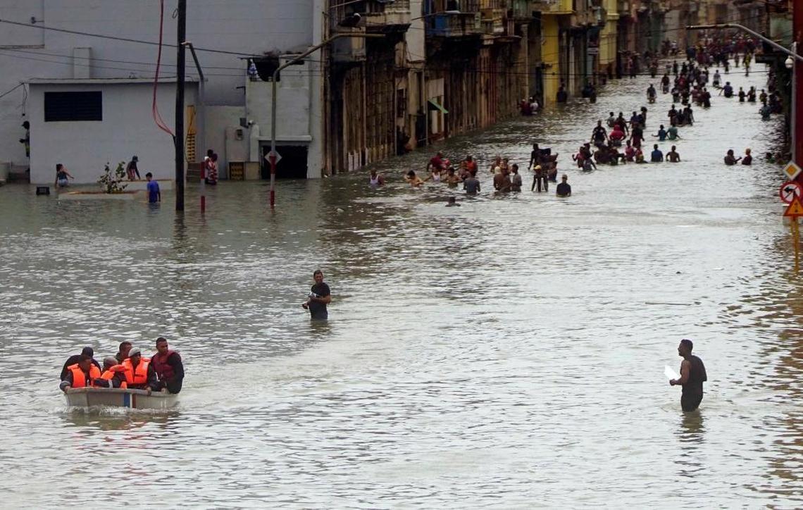 People move through flooded streets in Havana after the passage of Hurricane Irma on Sunday.