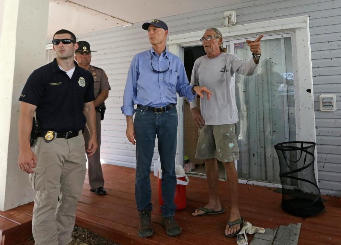 Gov. Rick Scott talks to Mark Finney, right, in the aftermath of Hurricane Irma, Wednesday, Sept. 13, 2017, in Big Pine Key, Fla. Finney, a tenant, stayed in the house that suffered some damages.
