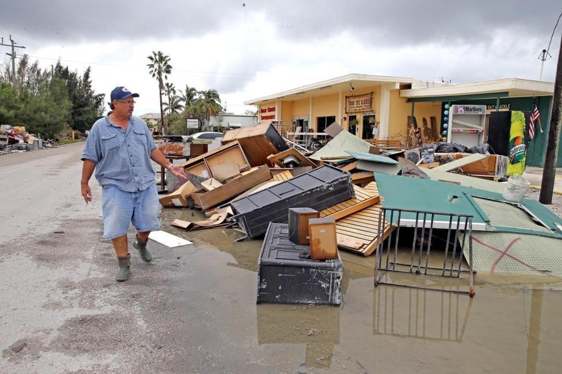 Mayor Howie Grimm walks by debris off the town circle in Everglades City. Grimm has vowed to speed up debris removal so residents aren’t constantly reminded of what they’ve lost as they rebuild.