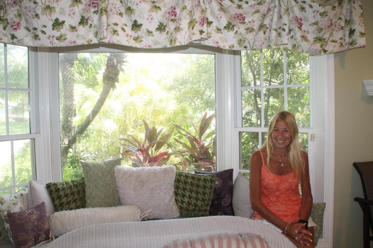 Lori Marcus sits in her rebuilt Country Walk home on Sept. 8, 2017. Hurricane Andrew destroyed her home in August 1992. The bay window blew out during the storm.