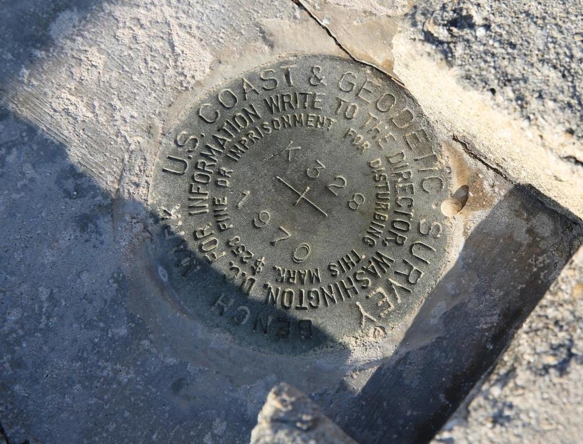 A U.S. Coast and Geodetic Survey benchmark from 1970 sits on a dock behind Strike Zone Charters near MM 29.7 in Big Pine Key. The benchmarks, installed over decades, tell surveyors, engineers, map makers and others exactly “where” they are, providing longitudes, latitudes and elevations. But the marks can sometimes be hard to find or get destroyed over the years. This one was last surveyed in 1987, according to field notes, providing USGS surveyors with a starting point in Big Pine to measure surge.