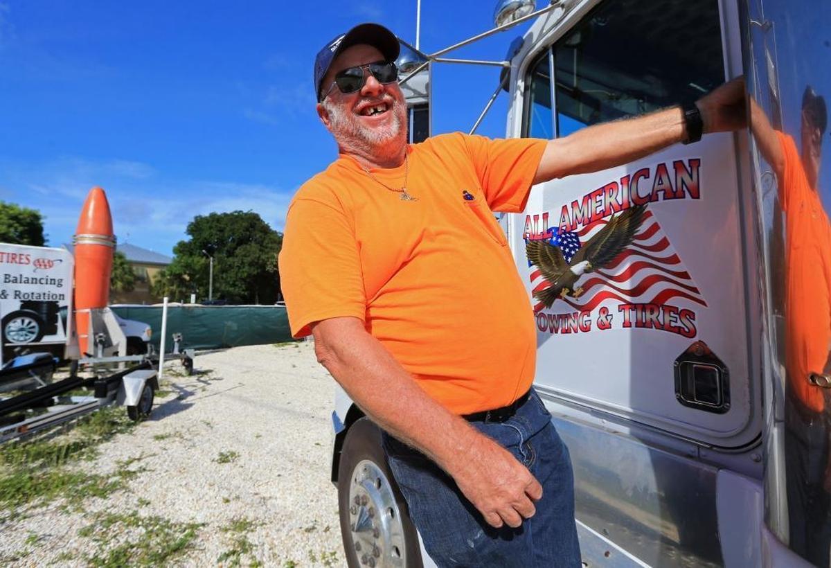 Jerry Norman, owner at All American Towing and Tires in Key Largo climbs onto his tow truck on Wednesday, Sept. 6. Norman will be staying at his shop during the impending storm to assist the city if there is damage from Hurricane Irma.