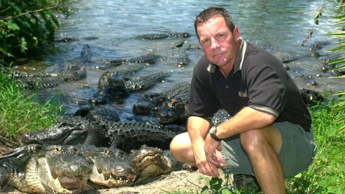 Mark McHugh, CEO of Gatorland, a reptile-filled attraction outside Orlando, Fla., poses with some of the animals on July 18, 2003. Now, as Hurricane Irma approaches, McHugh has taken to Facebook to assure people that his alligators won’t escape.