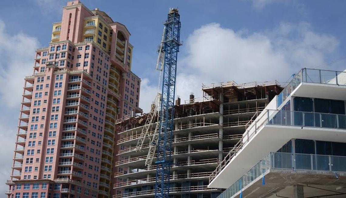 Part of a damaged crane brought down by Hurricane Irma rests against the construction site of the Auberge Beach Residences and Spa in Fort Lauderdale, Fla., Monday, Sept. 11, 2017. (