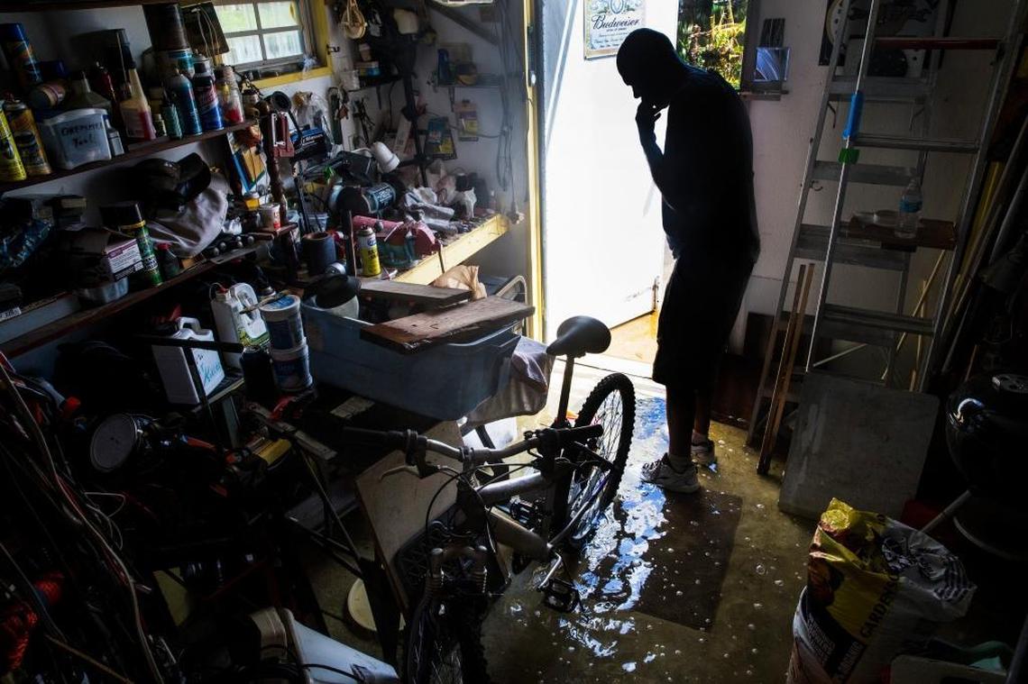 Dave Stroshein inspects the flooding in his shed at Citrus Park in Bonita Springs on Wednesday, Sept. 13, 2017, three days after Hurricane Irma.