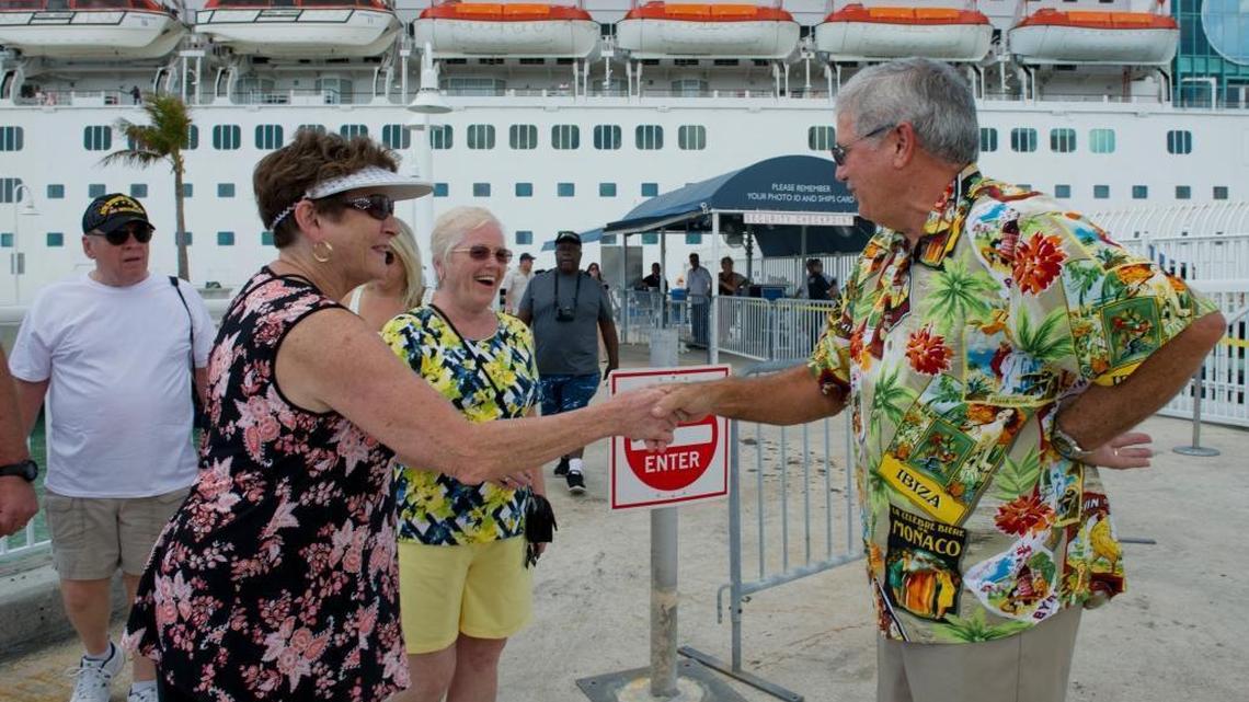 In this photo provided by the Florida Keys News Bureau, Key West Mayor Craig Cates, right, greets passengers from the Empress of the Seas cruise ship Sunday, Sept. 24, 2017, in Key West. The ship’s port call marked the first time a cruise ship has docked in Key West since Hurricane Irma.
