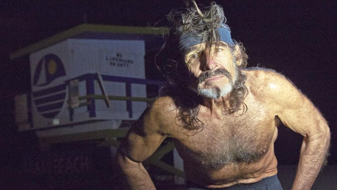 Robert “Raven” Kraft stops to be photographed after completing his 15,000th run on South Beach on Jan. 24, 2016. Kraft boasts he has run eight miles every day on the sands of South Beach since January 1, 1975.