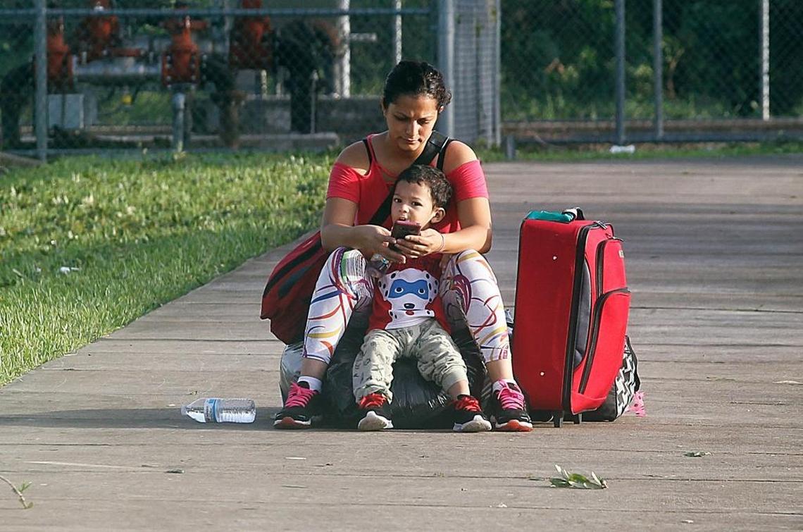 Yajaira Turcios and her son Eduard wait to be picked up to return home after spending three days at South Dade Middle School, a school turned hurricane shelter in Homestead, on Monday, Sept. 11, 2017. They evacuated from Hurricane Irma, which hit the Florida Keys early Sunday morning.