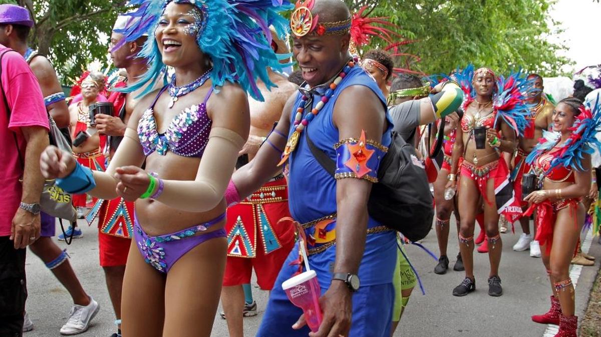 Carla Hill enjoys the music of Miami Broward Carnival as she parades and dances with her husband, Marlon Hill, right. Carnival lovers and revelers geared up for one of the most anticipated cultural Caribbean traditions, Miami Broward Carnival on Sunday, October 11, 2015 at the Miami Dade County Fair and Exposition.