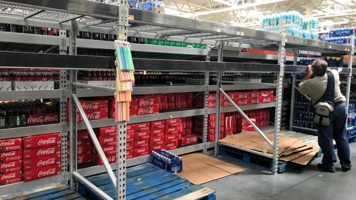 Shoppers were cleaning out the bottled water aisle Monday afternoon at the Walmart Supercenter at 3200 NW 79th St.