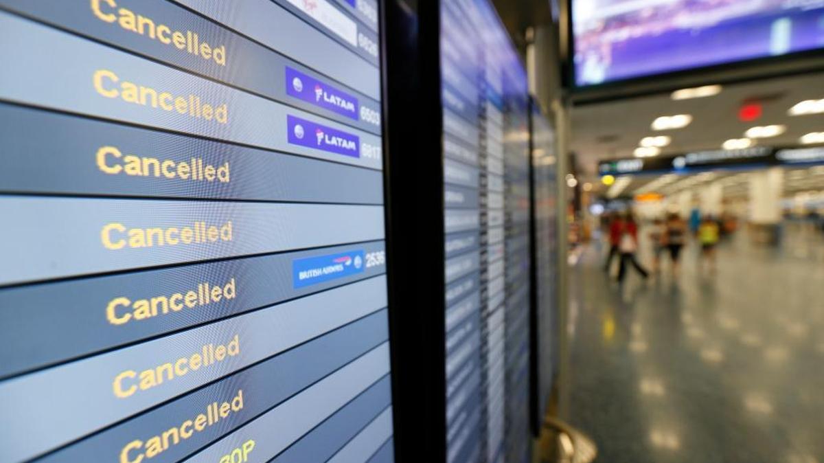 A monitor lists canceled flights at Miami International Airport on Friday. Miami and Fort Lauderdale will reopen on Tuesday with a limited number of flights.