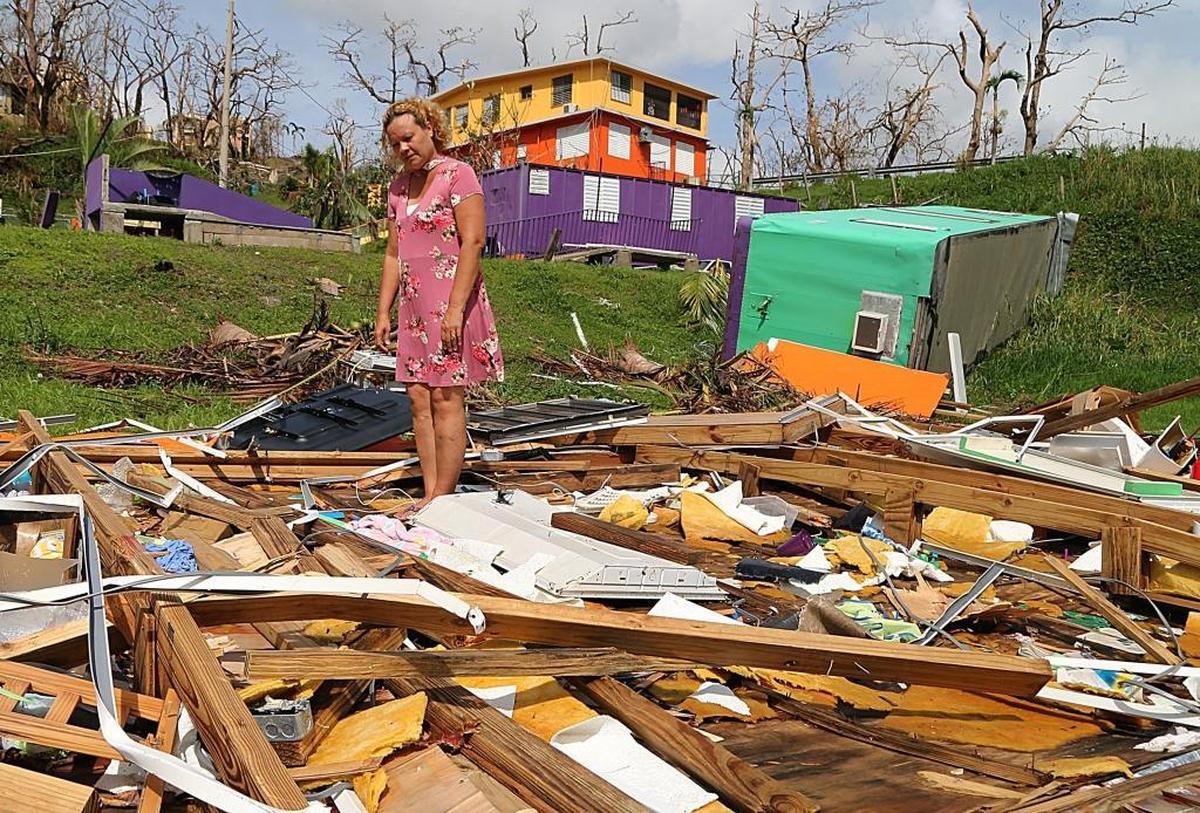 Principal Wanda Alvarez, stands on the debris of what used to be the classroom of the private school El Eden Paraiso Infantil, in the town of Yabucoa, Puerto Rico.