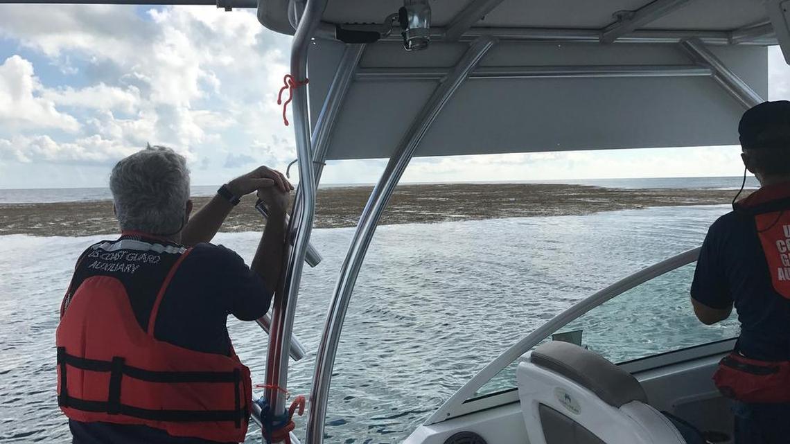 Members of the U.S. Coast Guard Auxiliary Flotilla 1308 observe a large weed line near Alligator Reef off Islamorada on Friday, Sept. 22.