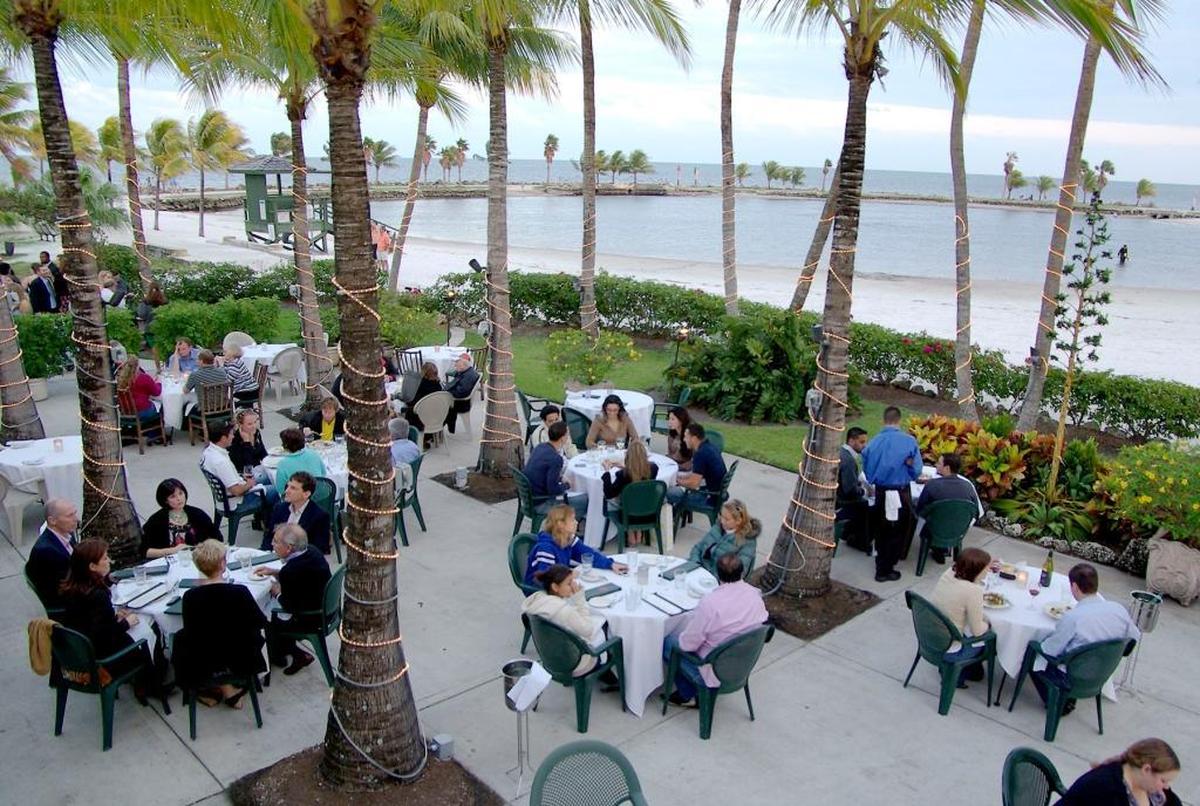 Patrons dine on the patio dining area that overlooks the water at Red Fish Grill in Coral Gables in this March 2008 file photo.