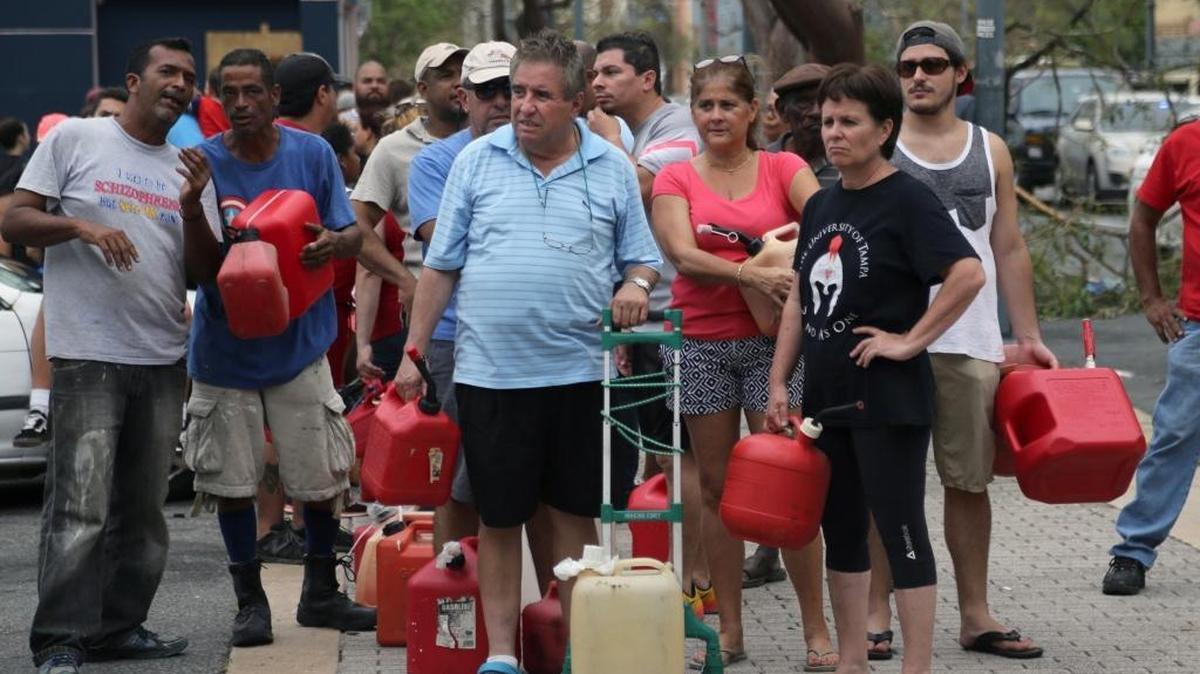 Residents form lines in cars and on foot to buy gas in San Juan on Friday.