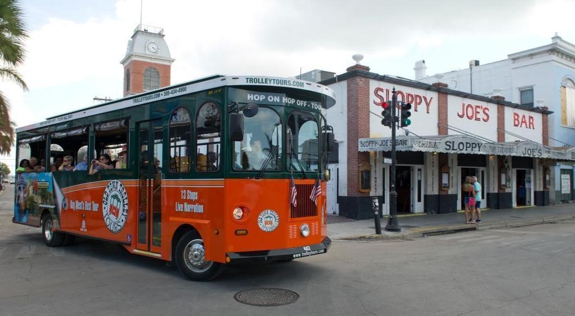 In this photo provided by the Florida Keys News Bureau, an Old Town Trolley, with cruise ship visitors onboard, passes Sloppy Joe's Bar Sunday, Sept. 24, 2017, in Key West, Fla. The arrival of Royal Caribbean's Empress of the Seas arrival was the first time a cruise ship has docked in Key West since prior to Hurricane Irma's passage through the Florida Keys.