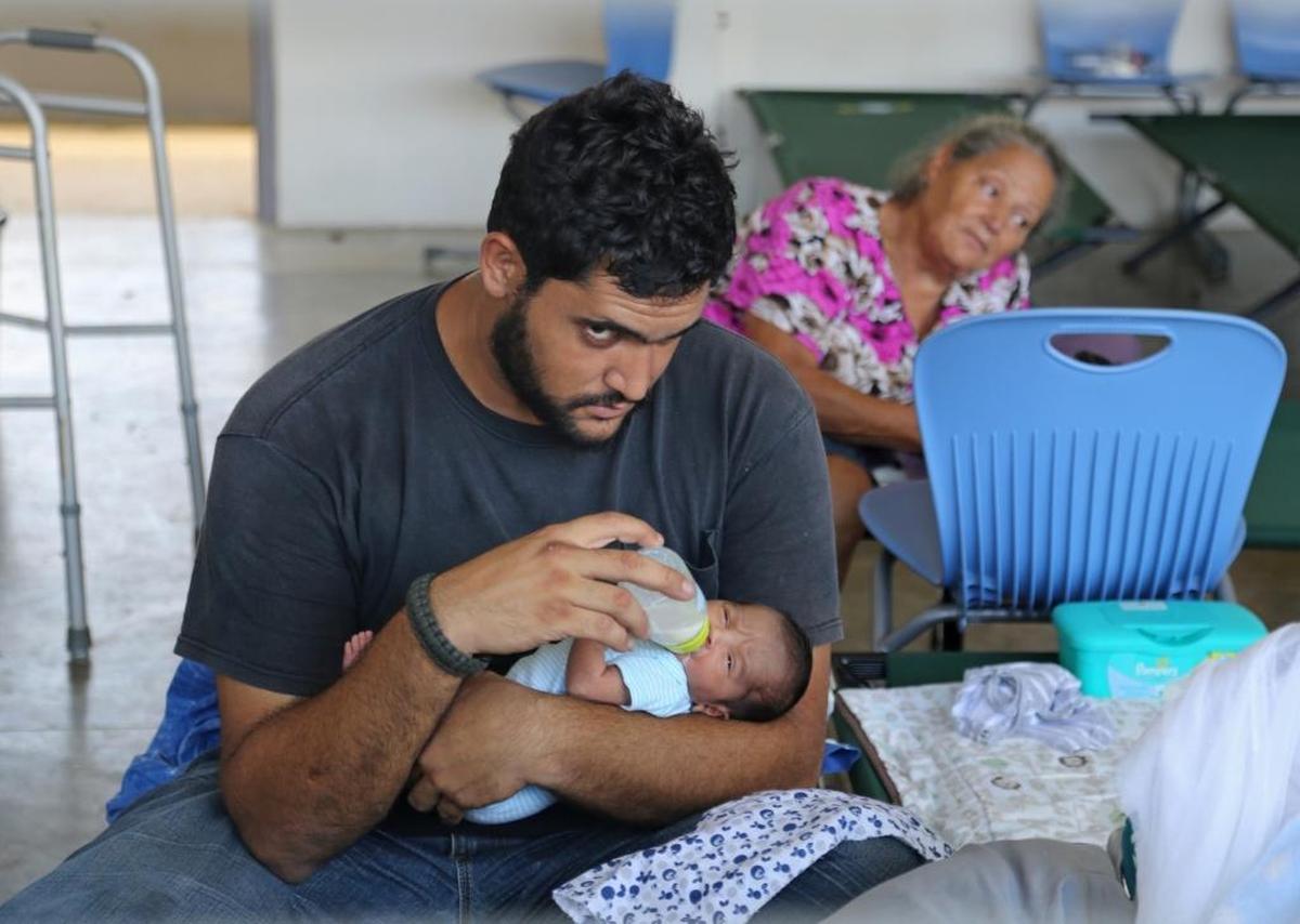 Isabela evacuee Geraldo Rodriguez feeds his new born son, Luis Alfredo Rodriguez, after finding shelter at the Francisco Mendoza High School in the center of Isabela, Puerto Rico, on Saturday, September 23, 2017.