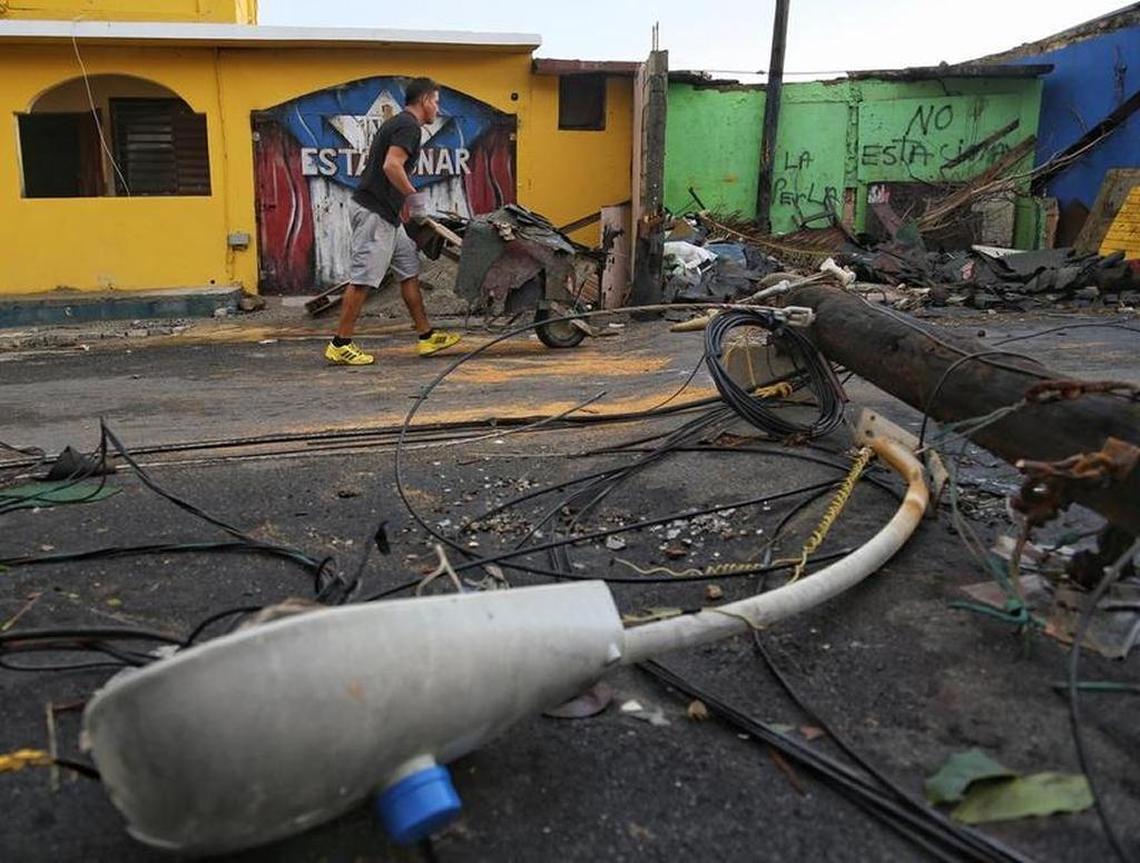 A resident of the Old San Juan section called La Perla wheels hurricane debris as the island U.S. territory recovers from the Category 4 Hurricane Maria.