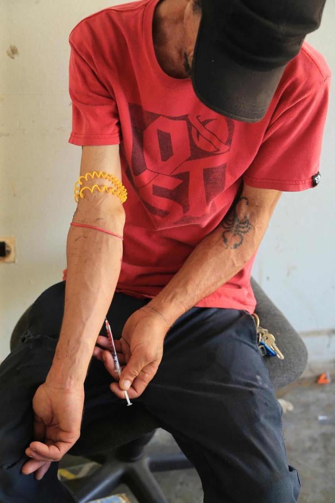 Carlos Perrios injects himself with drugs at an abandoned school in Cidra, Puerto Rico, on Thursday, October 19, 2017.