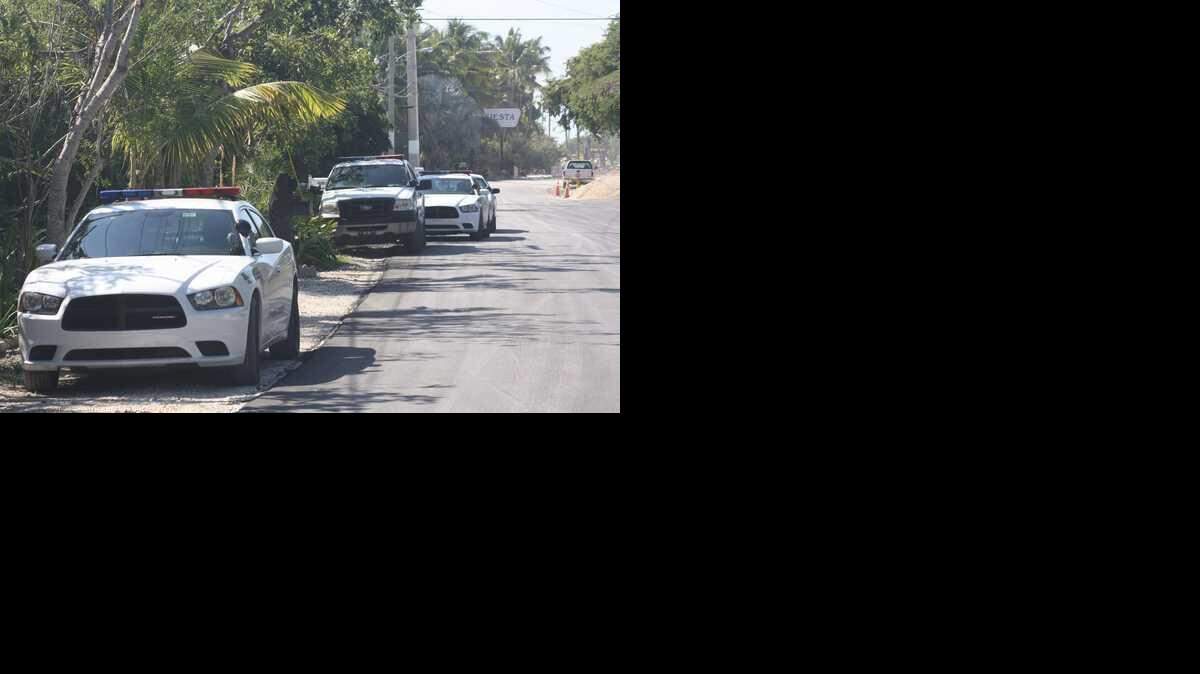 
Monroe County Sheriff's Office patrol cars line up in front of the home of Jeffrey Spencer Bennett, who faces a misdemeanor gun charge for allegedly shooting his rifle at an iguana.
