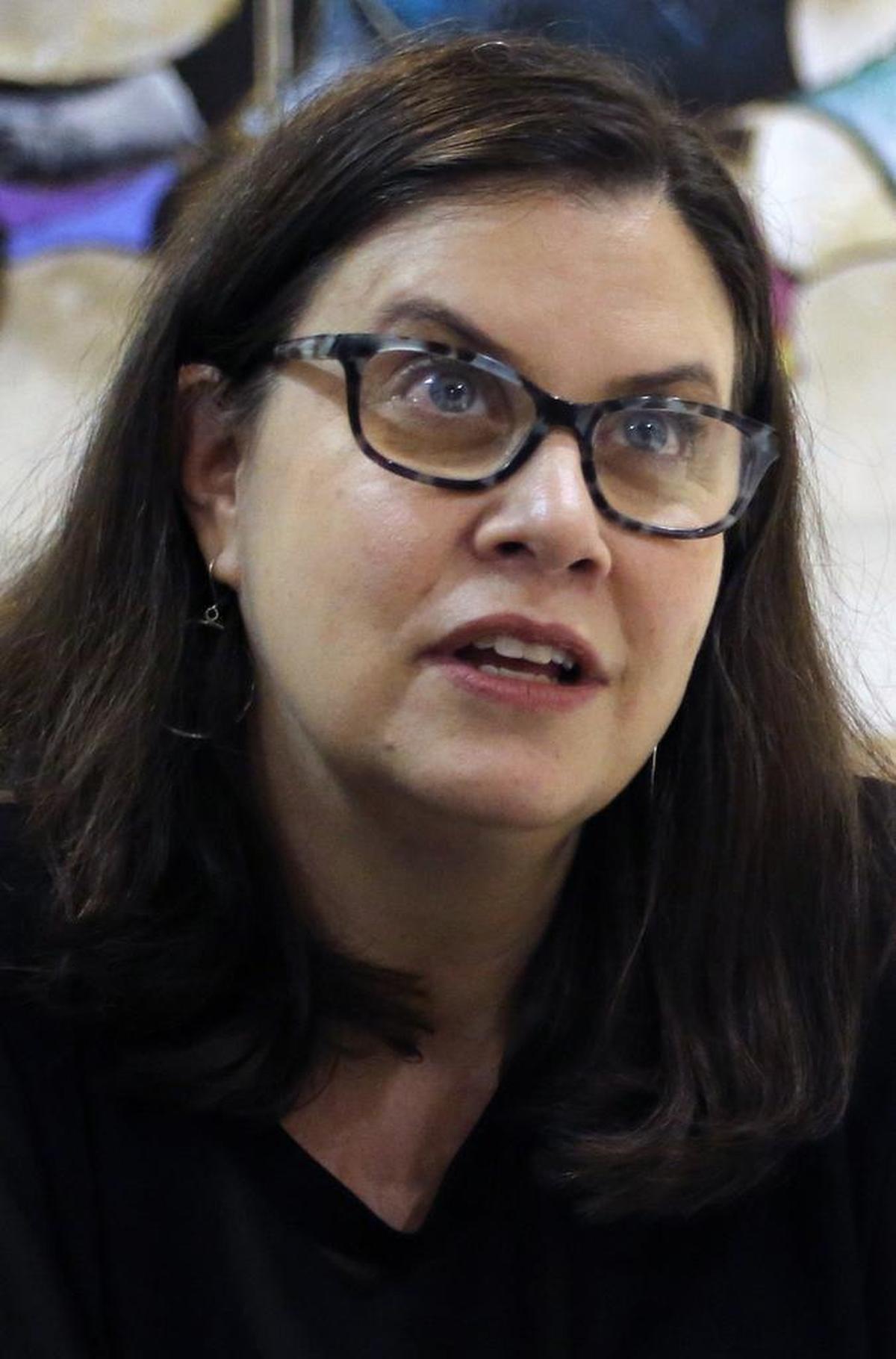 Alexandra Zapruder, granddaughter of Abraham Zapruder, who filmed the JFK assassination, signs copies of her book about the tension in and pressure on her family created by that home movie.