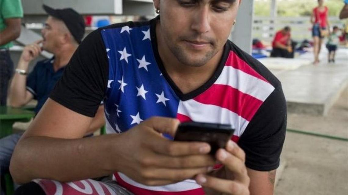 A Cuban migrant uses his phone at a shelter in La Cruz, Costa Rica.