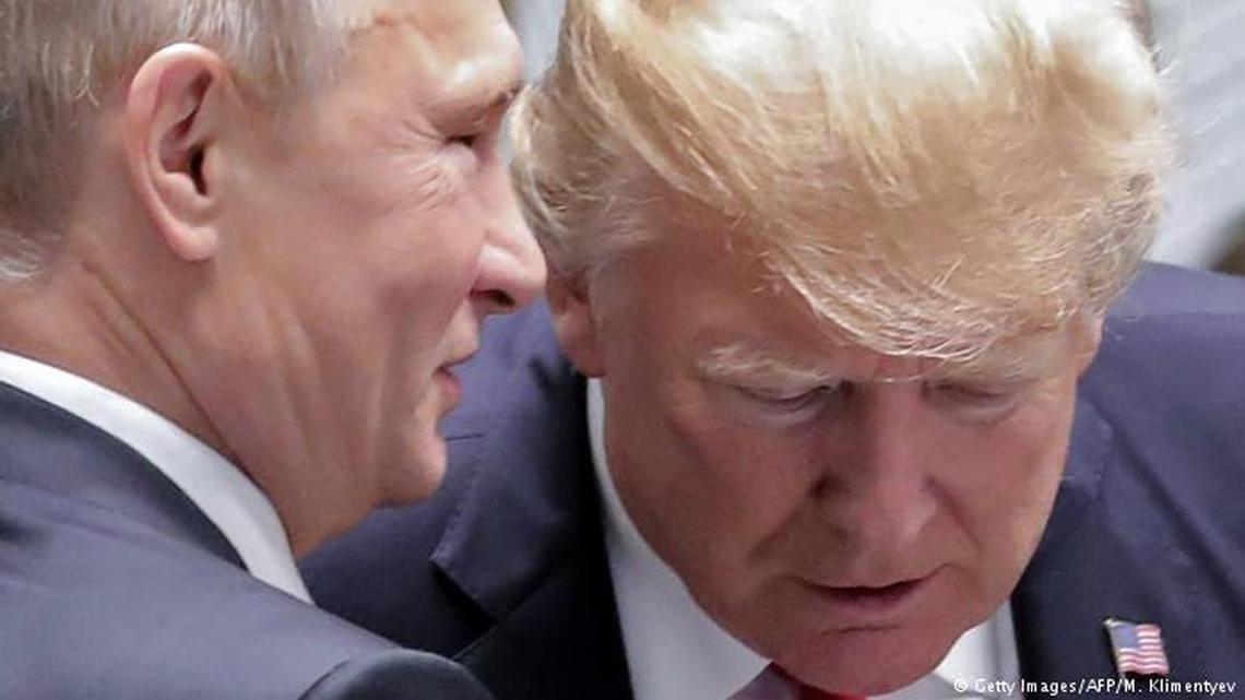 President Trump leans in to listen to Russian President Vladimir Putin.