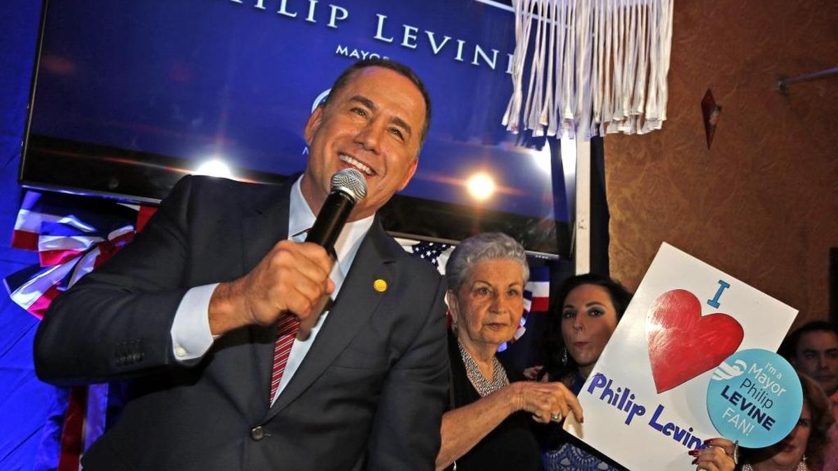 Miami Beach Mayor Philip Levine, with his mother Diane Ziman, wins reelection and greets his supporters Tuesday.