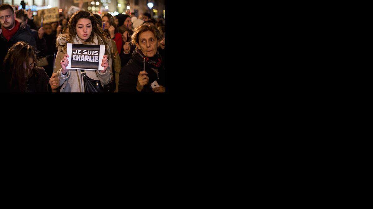 
THEY ARE ONE: A woman holds a poster reading ‘Je suis Charlie’ (I am Charlie) during a vigil in London’s Trafalgar Square for victims of the terrorist attack in Paris on Jan. 7. There were similar demonstrations on Sunday in Paris.
