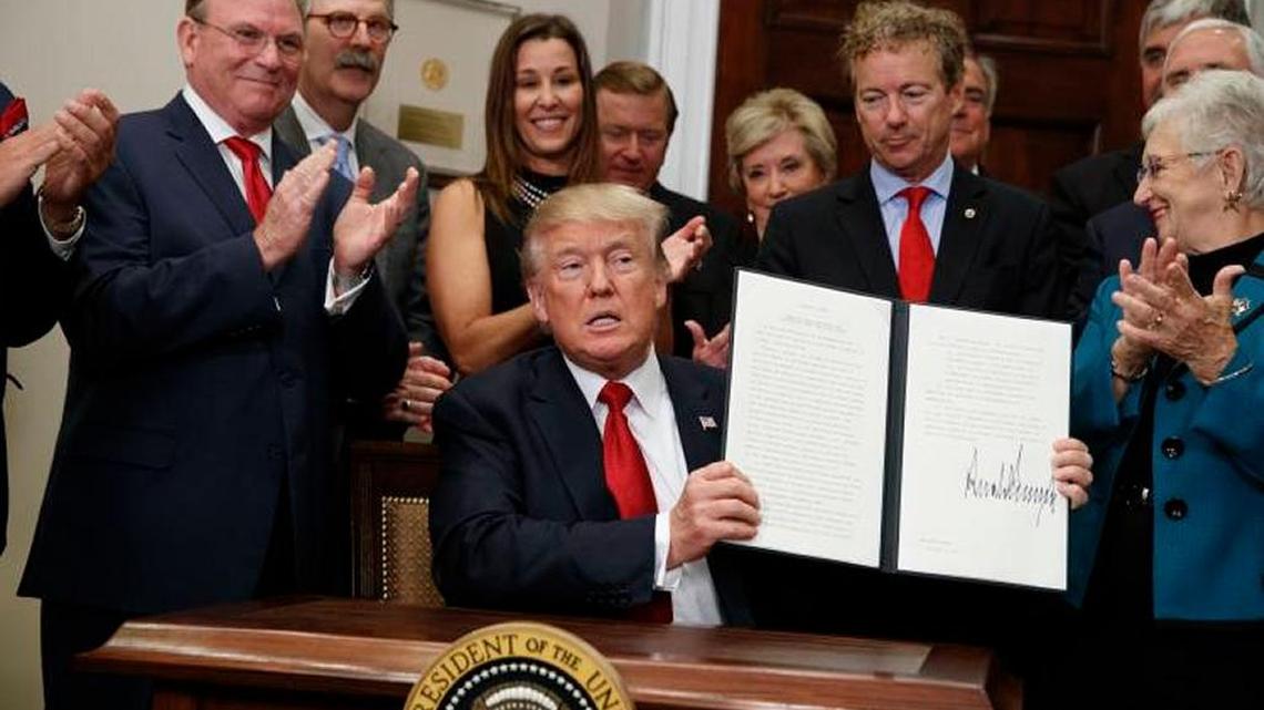 President Trump displays his executive order on healthcare, signed in the White House on Oct. 12.