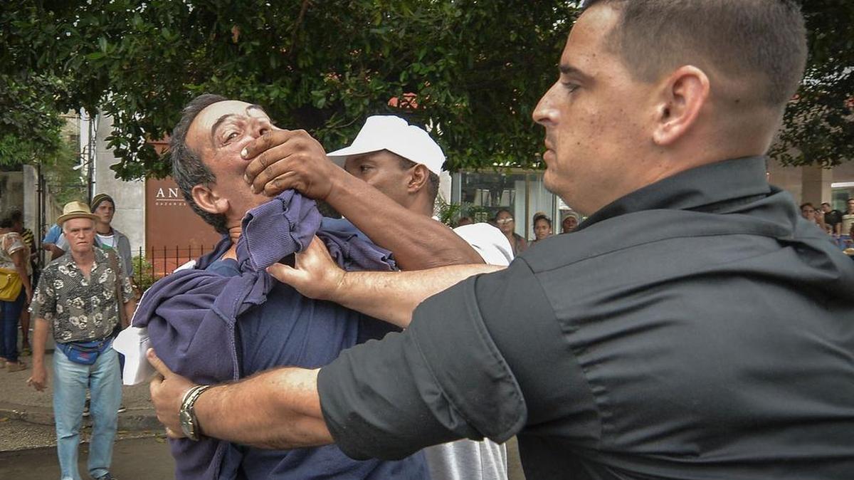Cuban dissident Yuri Valle Roca is silenced and arrested by Cuban police last week in Havana during a demonstration in observance of International Human Rights Day.