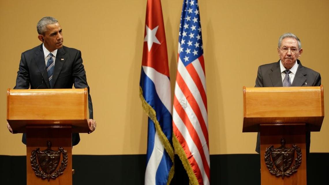 U.S. President Barack Obama, left, listens to Cuba’s President Raul Castro, during a joint statement in Havana on Monday. A cranky Castro asked for a list of Cuban political prisoners, when asked about them.